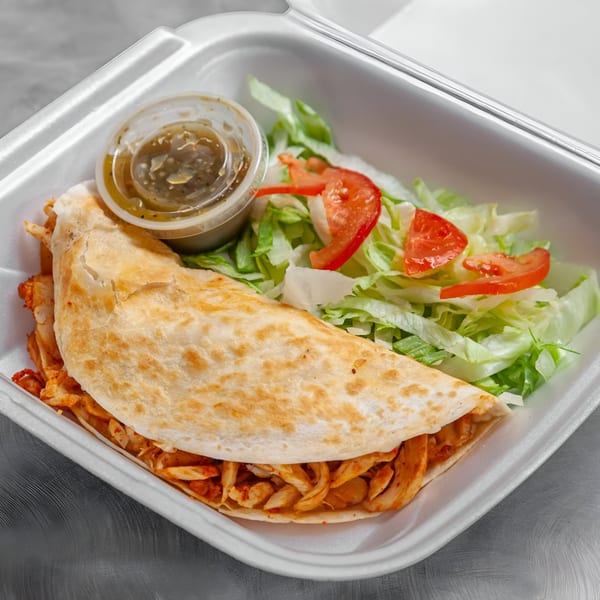 Takozz chicken quesadilla with a side salad and green salsa in a white takeout container.